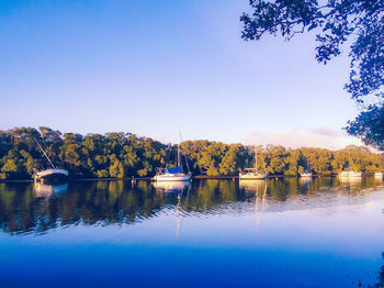 Scenic view of lake against clear blue sky