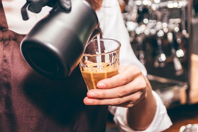 Close-up of hand holding coffee cup