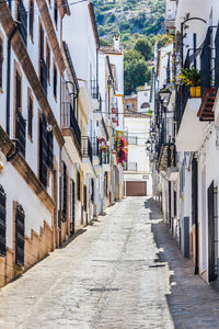 Narrow street amidst buildings in city