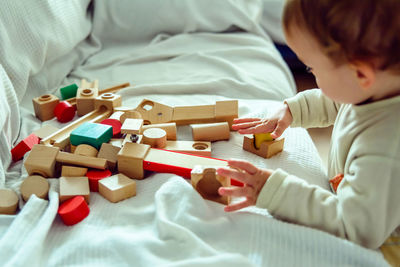 Boy playing with toys on sofa at home