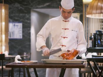 Man preparing food on table in restaurant