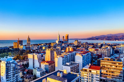 High angle view of buildings against sky during sunset