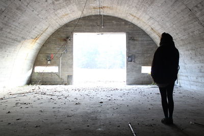 Rear view of a woman standing in corridor