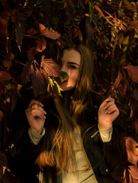 Portrait of young woman with leaves
