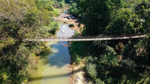 High angle view of bridge amidst trees in forest