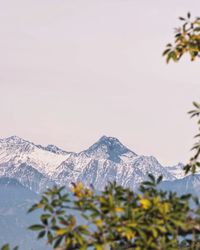 Close-up of snow covered mountains against clear sky