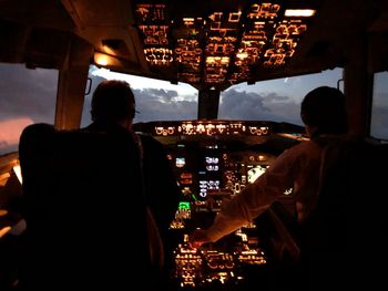 Rear view of man working at airplane