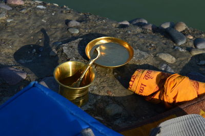 High angle view of brass utensils near a  river for religious work