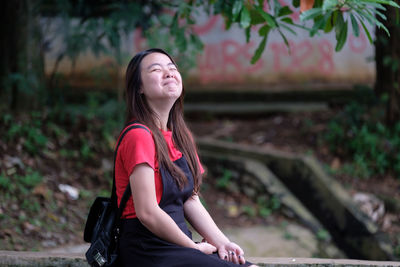 Smiling young woman at park