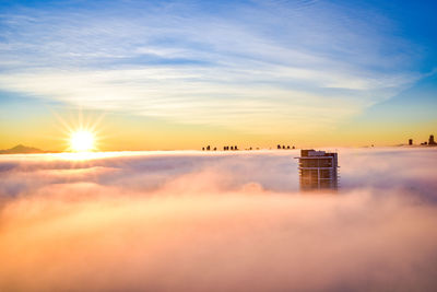 Scenic view of building against sky during sunset