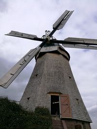 Low angle view of traditional windmill against sky