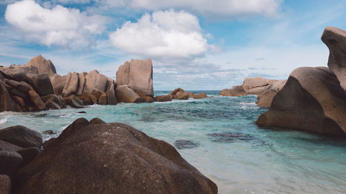 Rocks on beach against sky