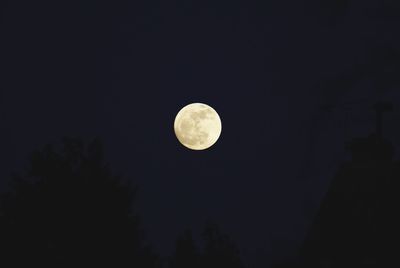 Low angle view of moon against clear sky at night