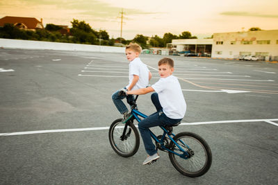 Boy riding bicycle on road