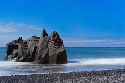 Scenic view of sea against blue sky