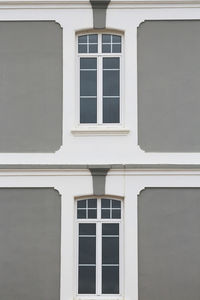 Front view of a facade painted in grey and white.