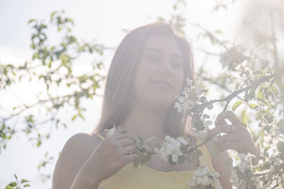 Portrait of young woman holding flower