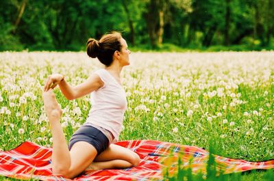 Girl jumping on grassy field