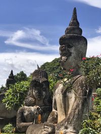 Statue against temple against sky