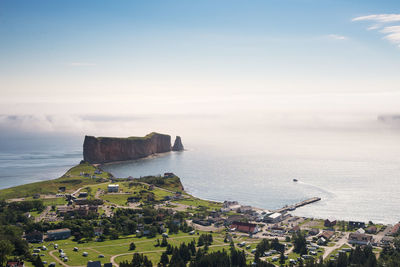 High angle view of sea and buildings against sky