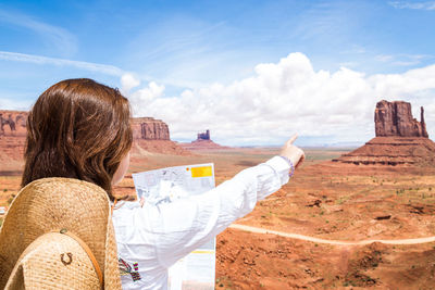 Rear view of woman against sky