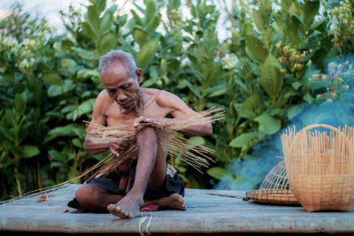 Full length of man sitting in basket