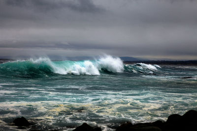 Waves breaking against sea