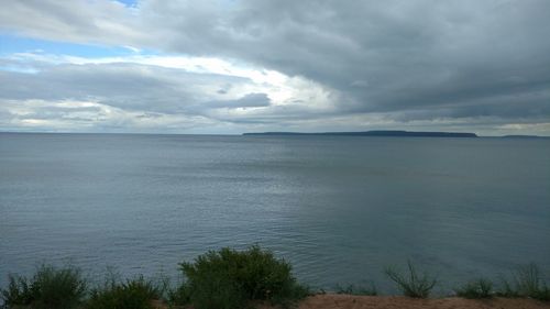 Scenic view of sea against cloudy sky