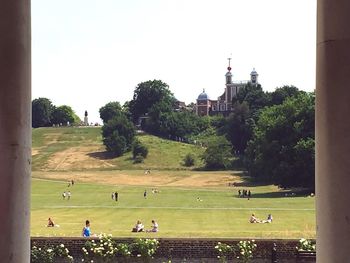 People on field against clear sky