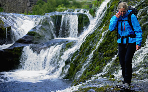 Woman exploring waterfalls at gjáin in the Þjórsárdalur valley