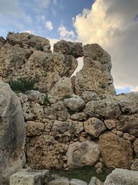 Low angle view of rock formation against sky