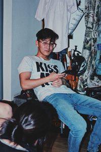 Portrait of young man sitting at home