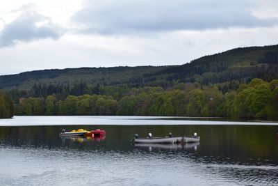 Boat in lake against sky