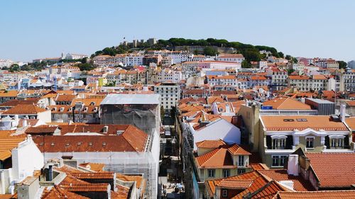 High angle view of houses in town against clear sky