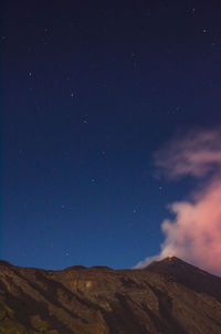 Low angle view of mountain against sky at night