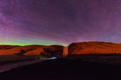 Scenic view of mountain against sky at night