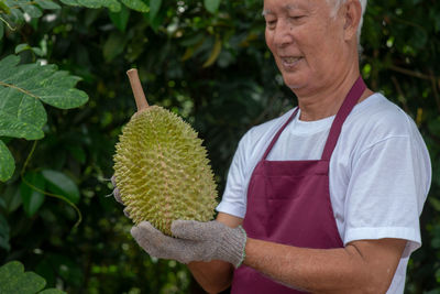 Midsection of man working with plants