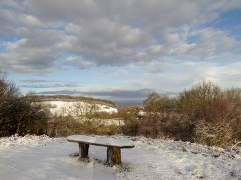 Snow covered field against sky