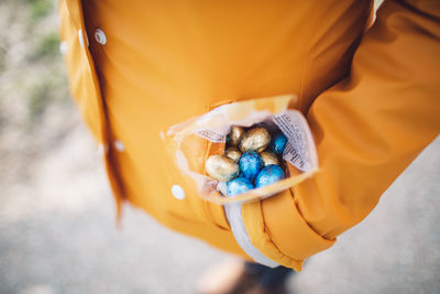 High angle view of person holding chocolate eggs