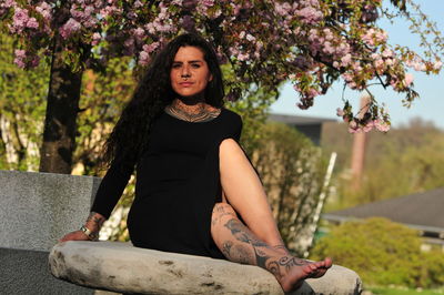 Portrait of young woman sitting outdoors