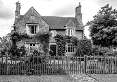 Exterior of house by building against sky