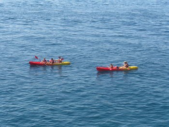 High angle view of people sitting in boats on sea