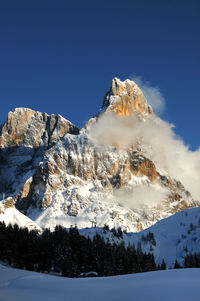 Scenic view of snowcapped mountains against clear blue sky