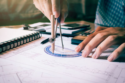 Close-up of hands working on table