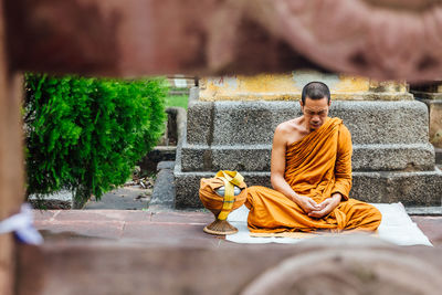 Rear view of man sitting on temple