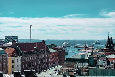 High angle view of townscape by sea against sky