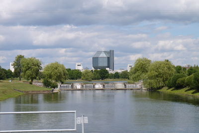 River in city against cloudy sky