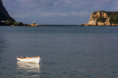 Sailboat in sea against sky