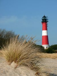 Low angle view of lighthouse against sky at beach