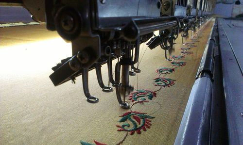 Sewing machines over fabric at factory